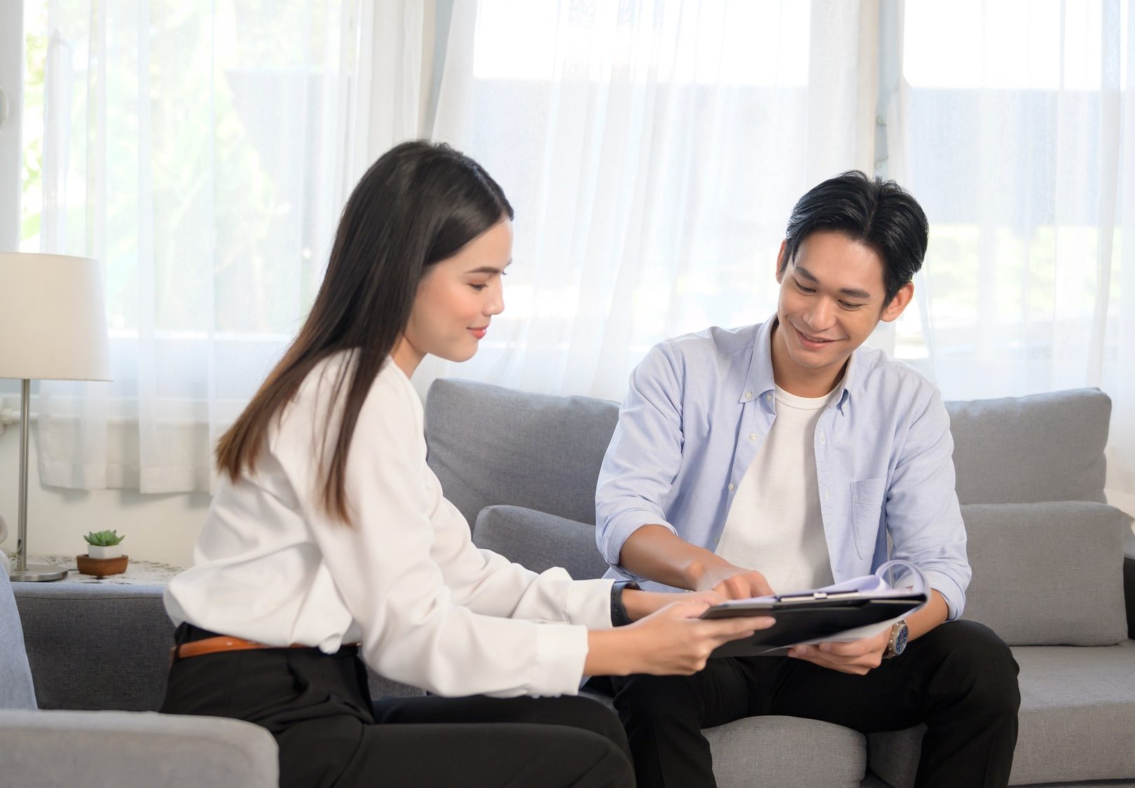 Man meeting with female real estate agent offering promotions
